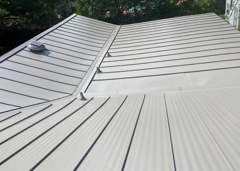 Solar attic fan installed on a metal roof for Roof Ventilation in West Perrine
